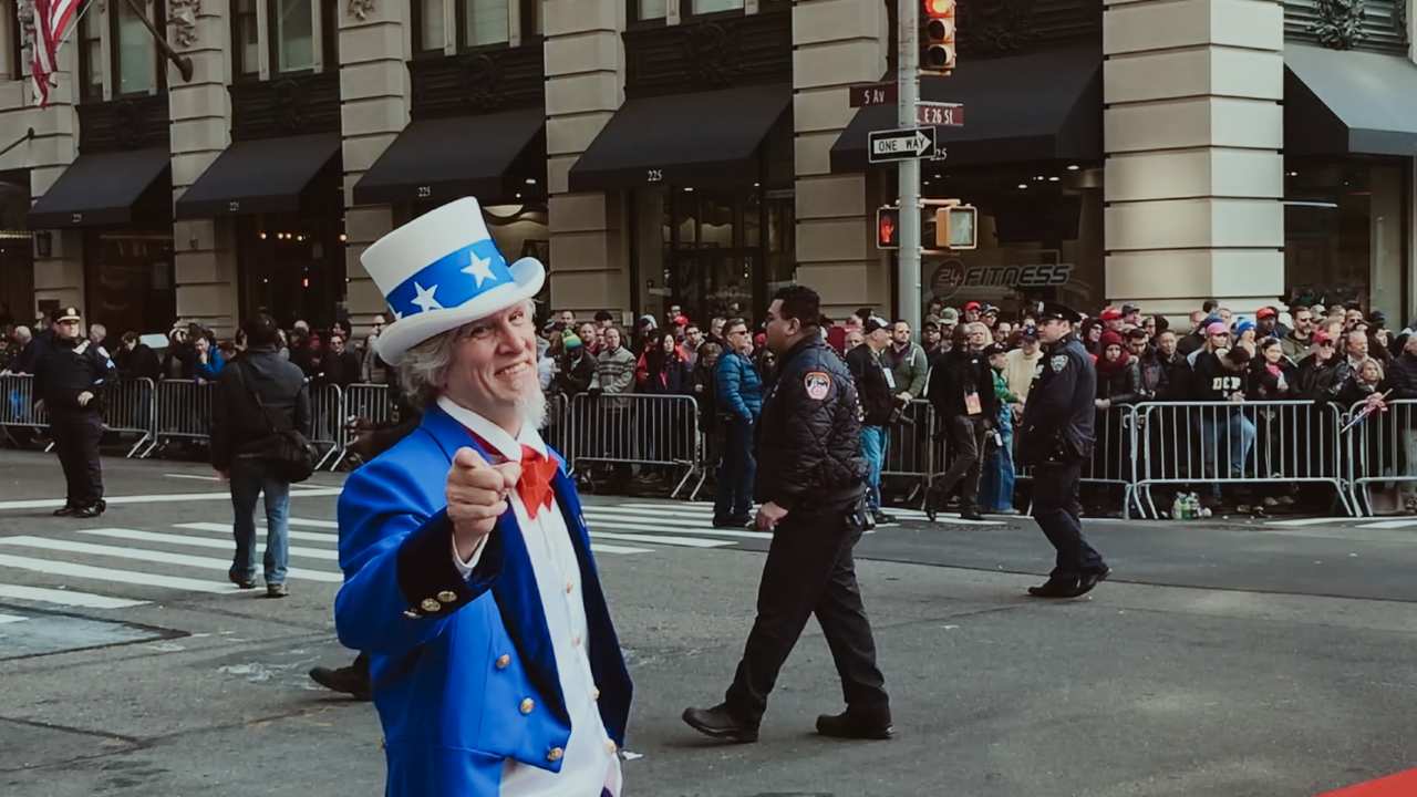 a man dressed as Uncle Sam pointing at the camera